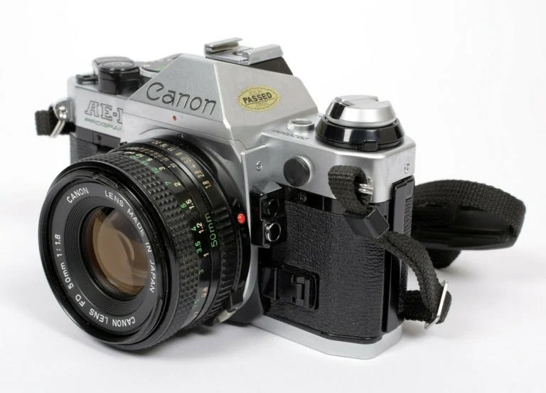 Canon AE-1 35mm SLR Film Camera w/ 50mm F/1.8 Lens - Refurbished